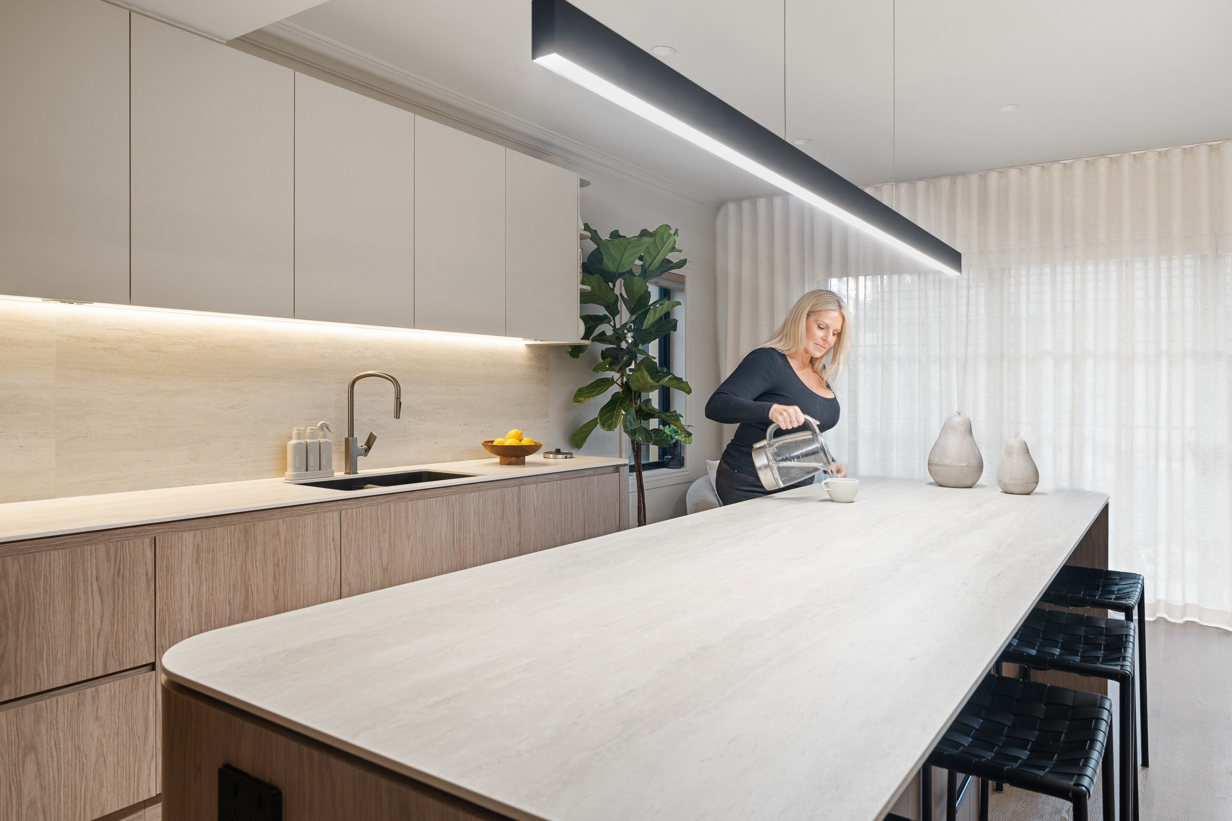 Alpine Beech hybrid flooring in a contemporary apartment kitchen with a stone island bench