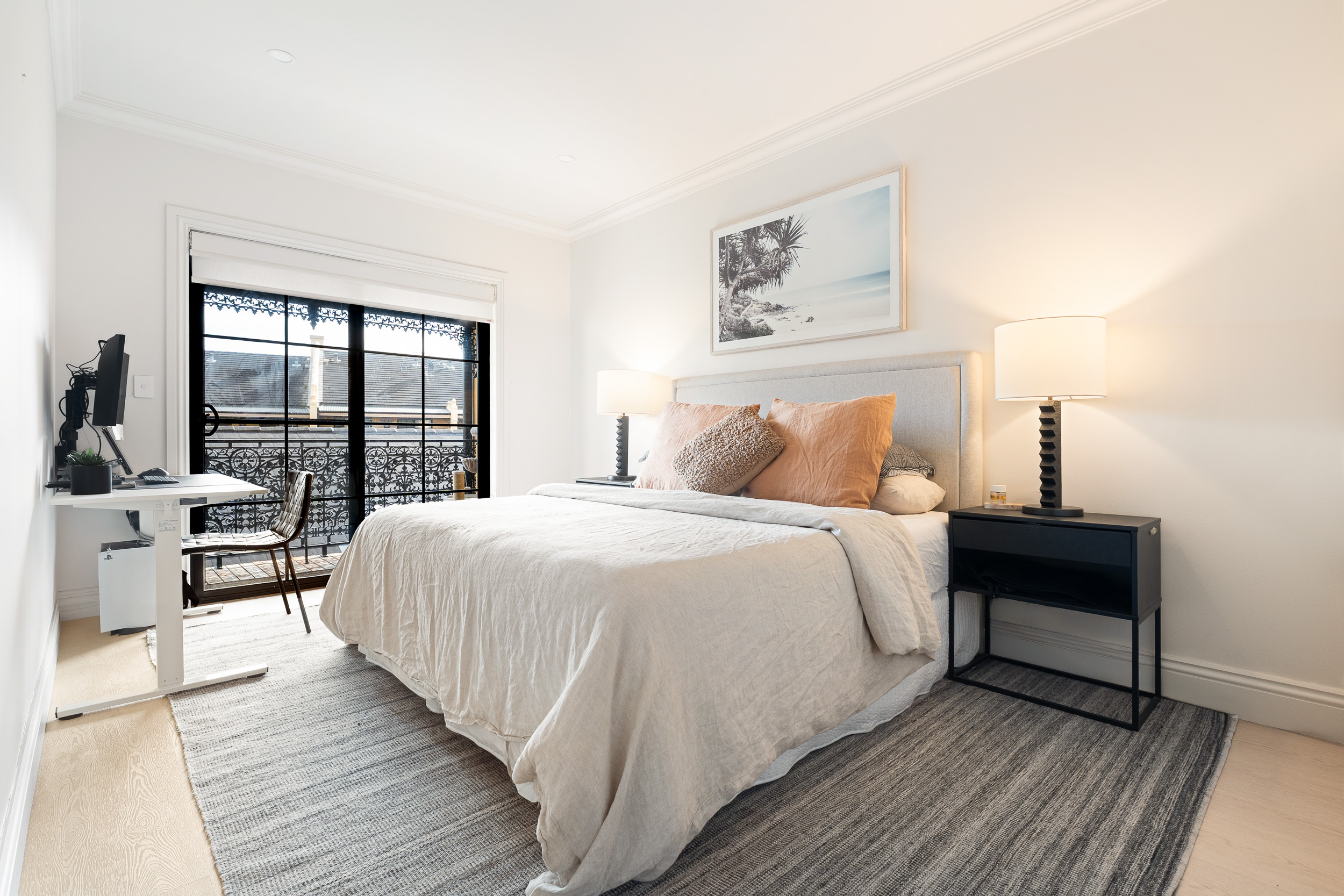 Alpine Beech hybrid flooring in a second bedroom with a desk and balcony