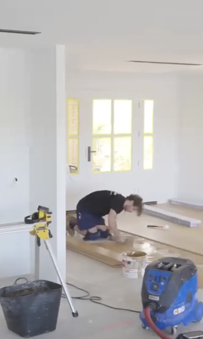 Installer working on light wood flooring available now from Beare Flooring.