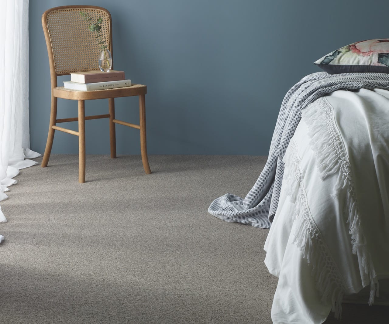 Beige carpet available now from Beare Flooring in a cosy bedroom setting.